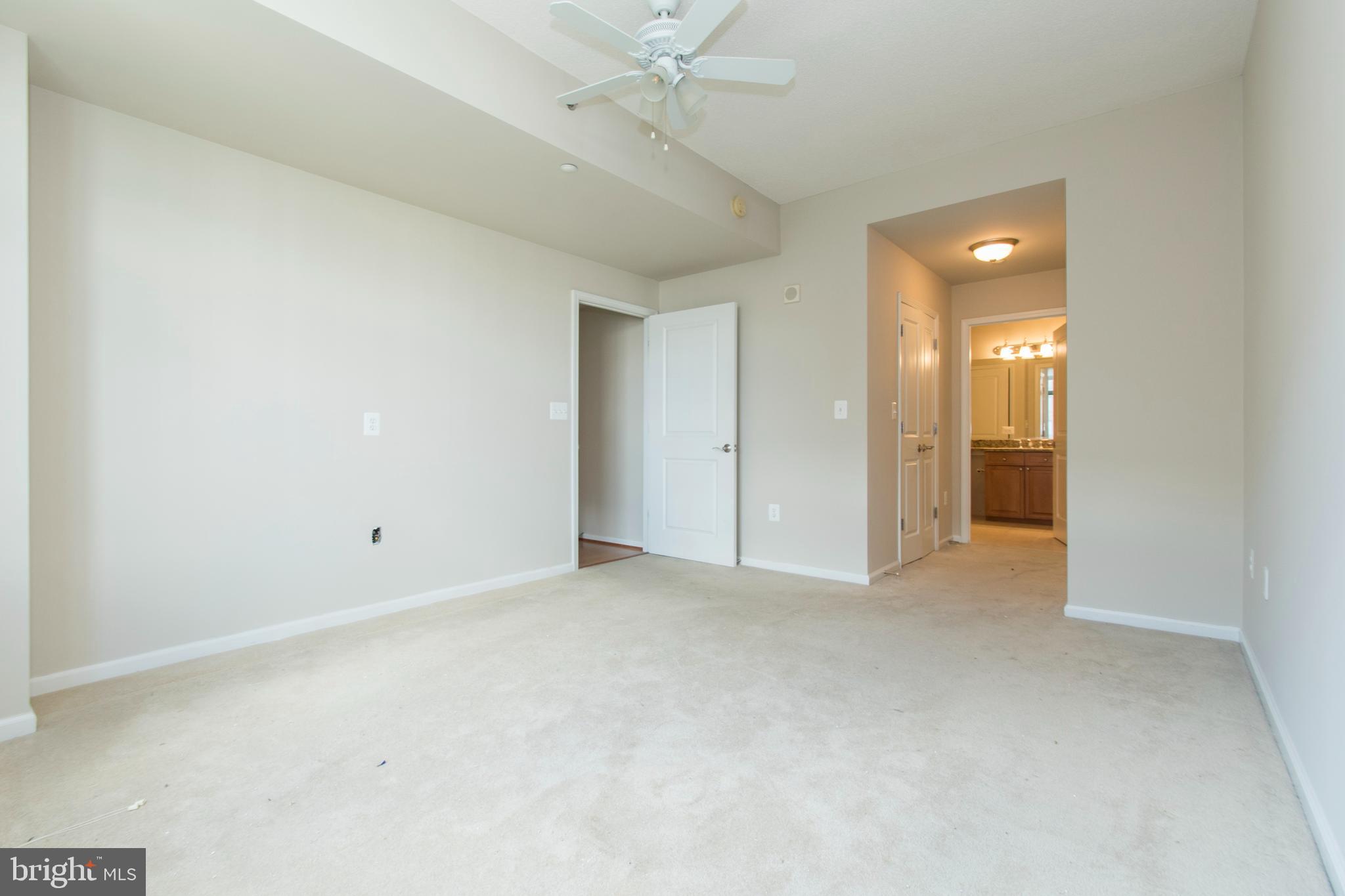 11700 Old Georgetown Road, Unit 807 North Bethesda, MD 20852 - Photo 16 of 37 an empty room with a bathroom and a ceiling fan
