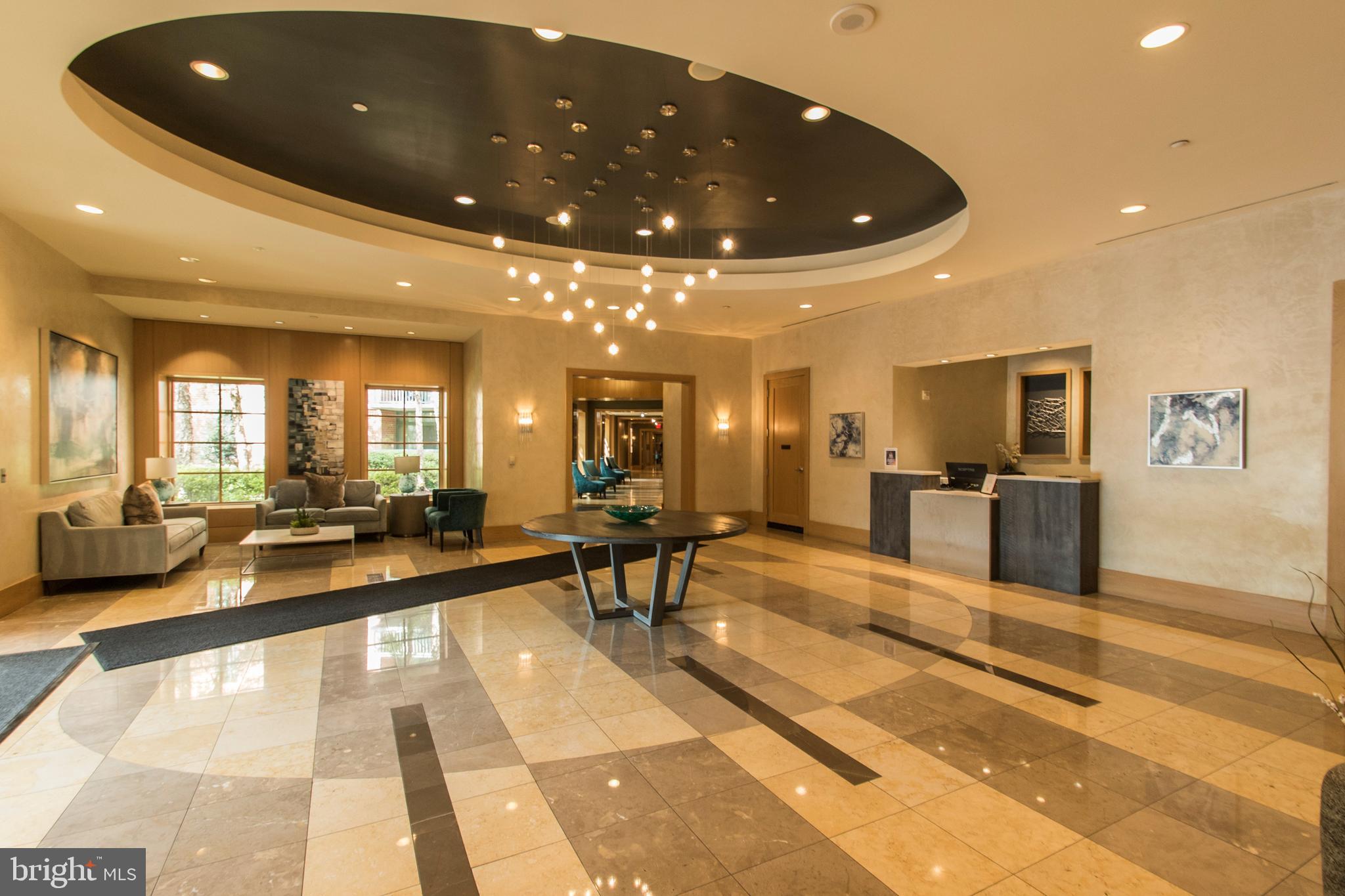 11700 Old Georgetown Road, Unit 807 North Bethesda, MD 20852 - Photo 5 of 37 a lobby with furniture and a dining table with chandelier