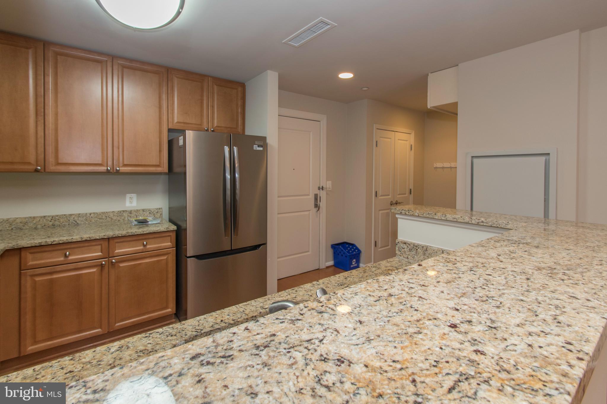 11700 Old Georgetown Road, Unit 807 North Bethesda, MD 20852 - Photo 8 of 37 a kitchen with a refrigerator and a stove top oven