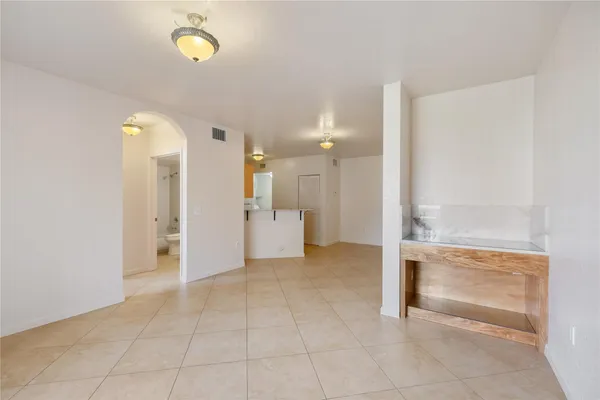 a view of a hallway with closet and a bathroom