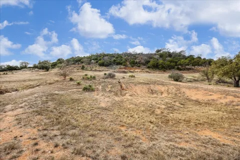 a view of a yard with snow on the road