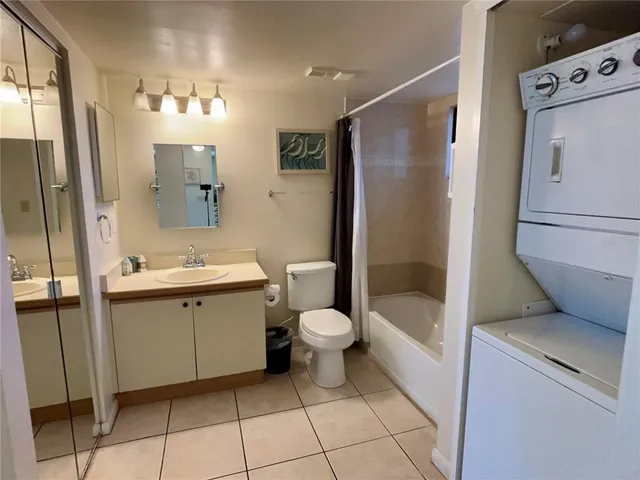 a bathroom with a double vanity sink toilet and shower
