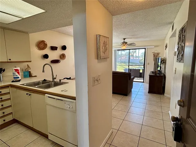 a kitchen with stainless steel appliances a stove a sink and a refrigerator
