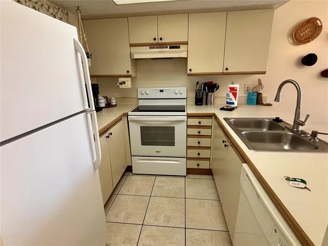 a kitchen with a stove a sink and a refrigerator