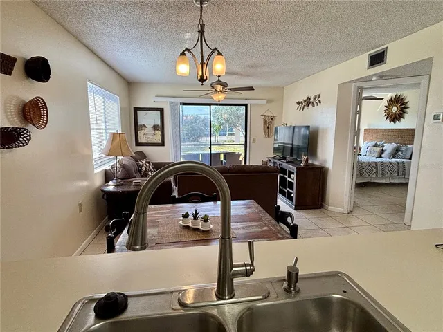 a kitchen with a sink a stove and a chandelier