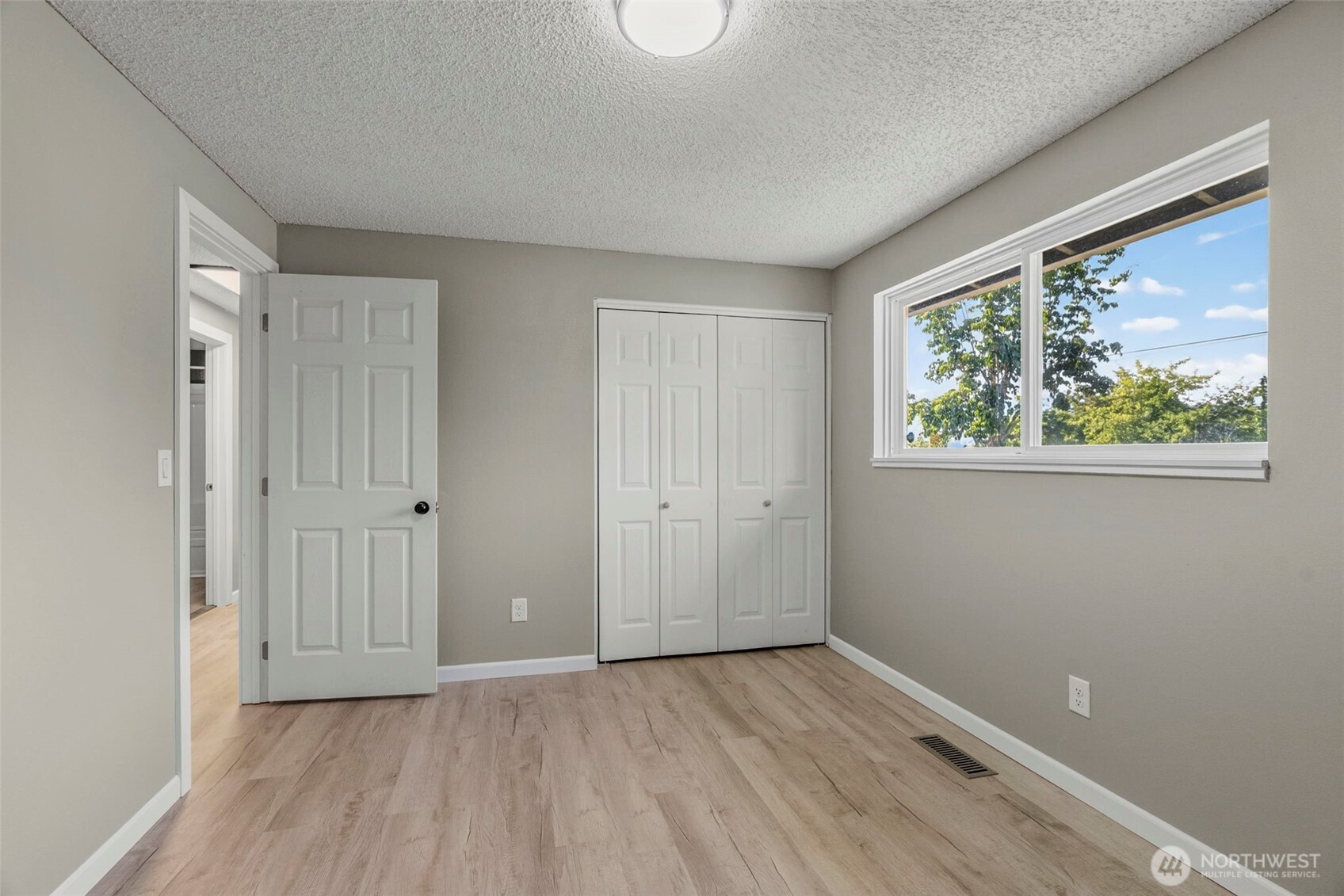 202 Waters Road Castle Rock, WA 98611 - Photo 33 of 38 a view of an empty room with wooden floor and a window