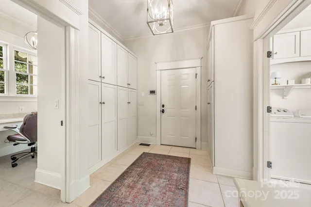 a view of a hallway with closet and a window