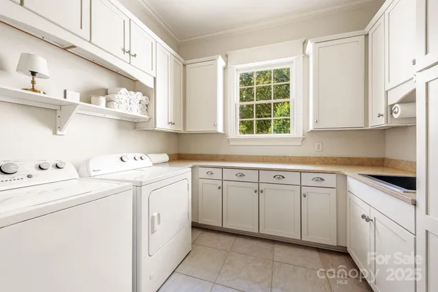 a kitchen with cabinets appliances a sink and a window