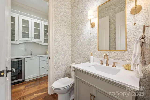 a bathroom with a granite countertop toilet sink and mirror