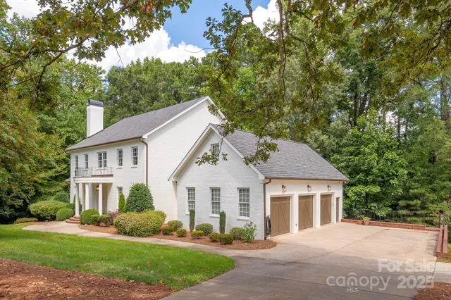 a front view of a house with a yard and trees