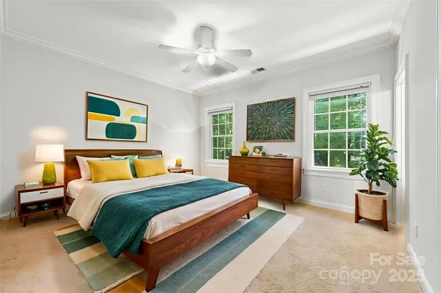 a spacious bedroom with a bed and a large window