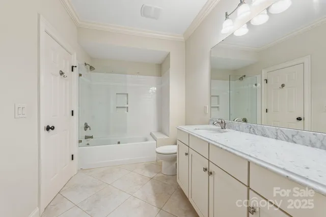 a spacious bathroom with a granite countertop sink a toilet and shower