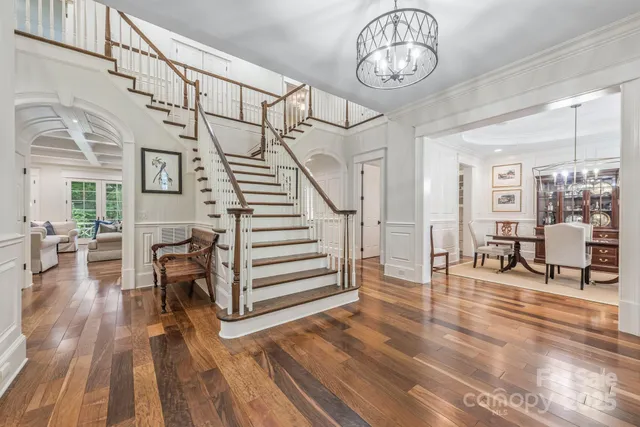 a view of entryway livingroom and hall with wooden floor