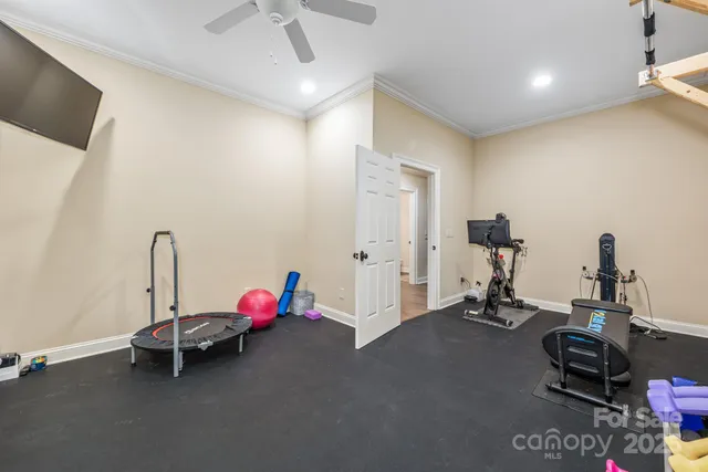 a room with gym equipment and a flat screen tv