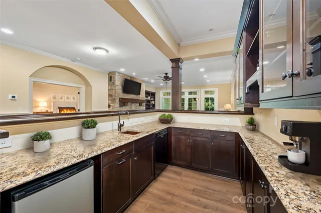 a living room with furniture a wooden floor and next to a window