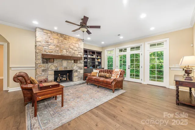 a view of a bedroom with wooden floor and window