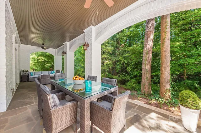 a view of a house with backyard and sitting area