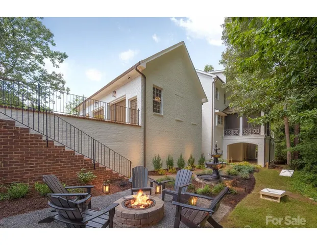 a view of a house with garden and trees