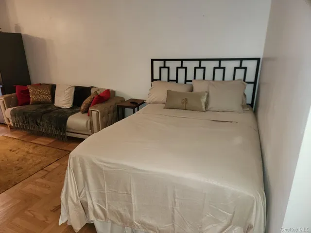 a large bed in a bedroom next to a window