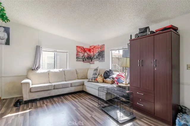 a living room with furniture wooden floor and window