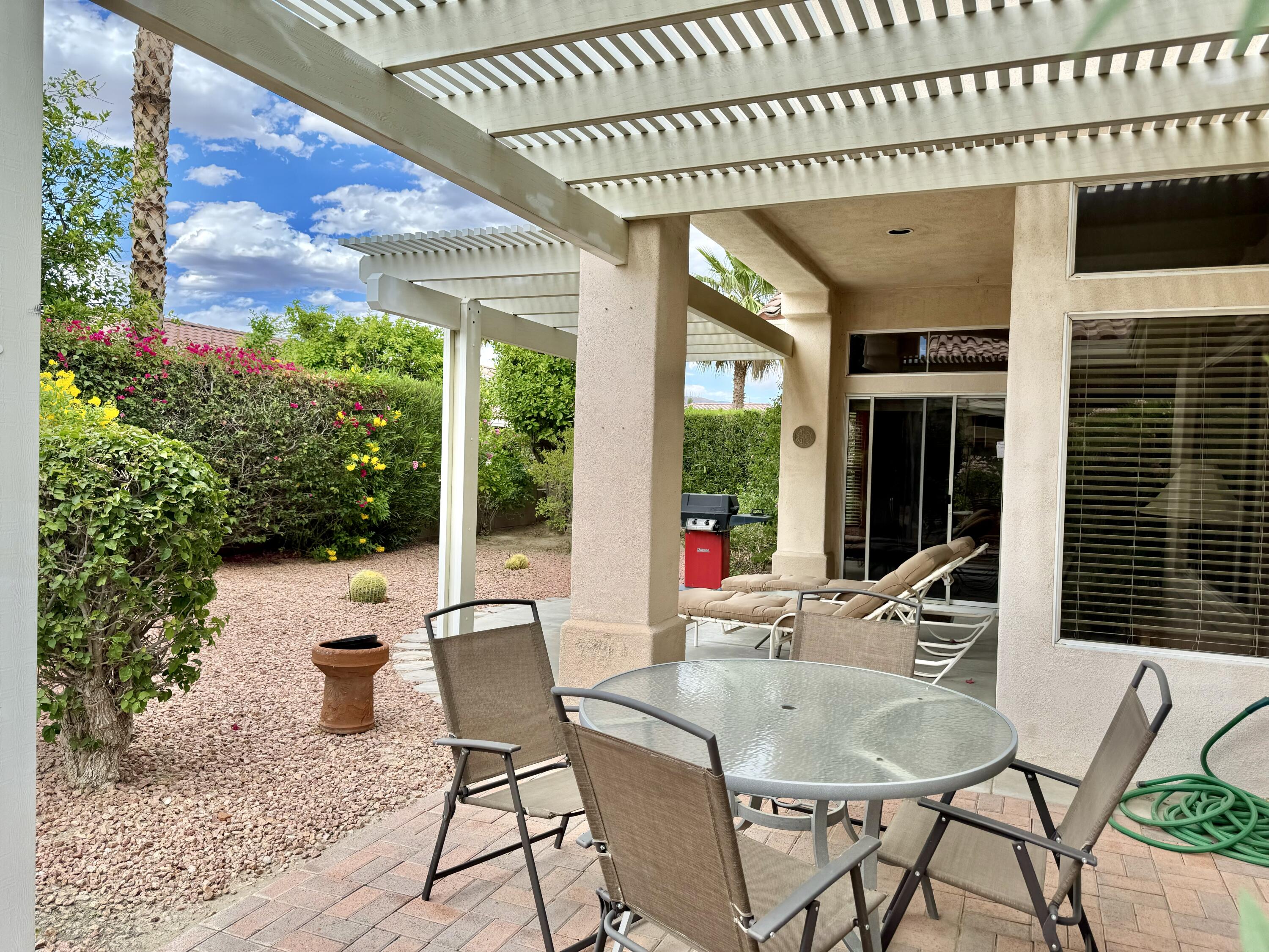 78376 Moongold Road Palm Desert, CA 92211 - Photo 15 of 36 a dining room with furniture and outdoor space