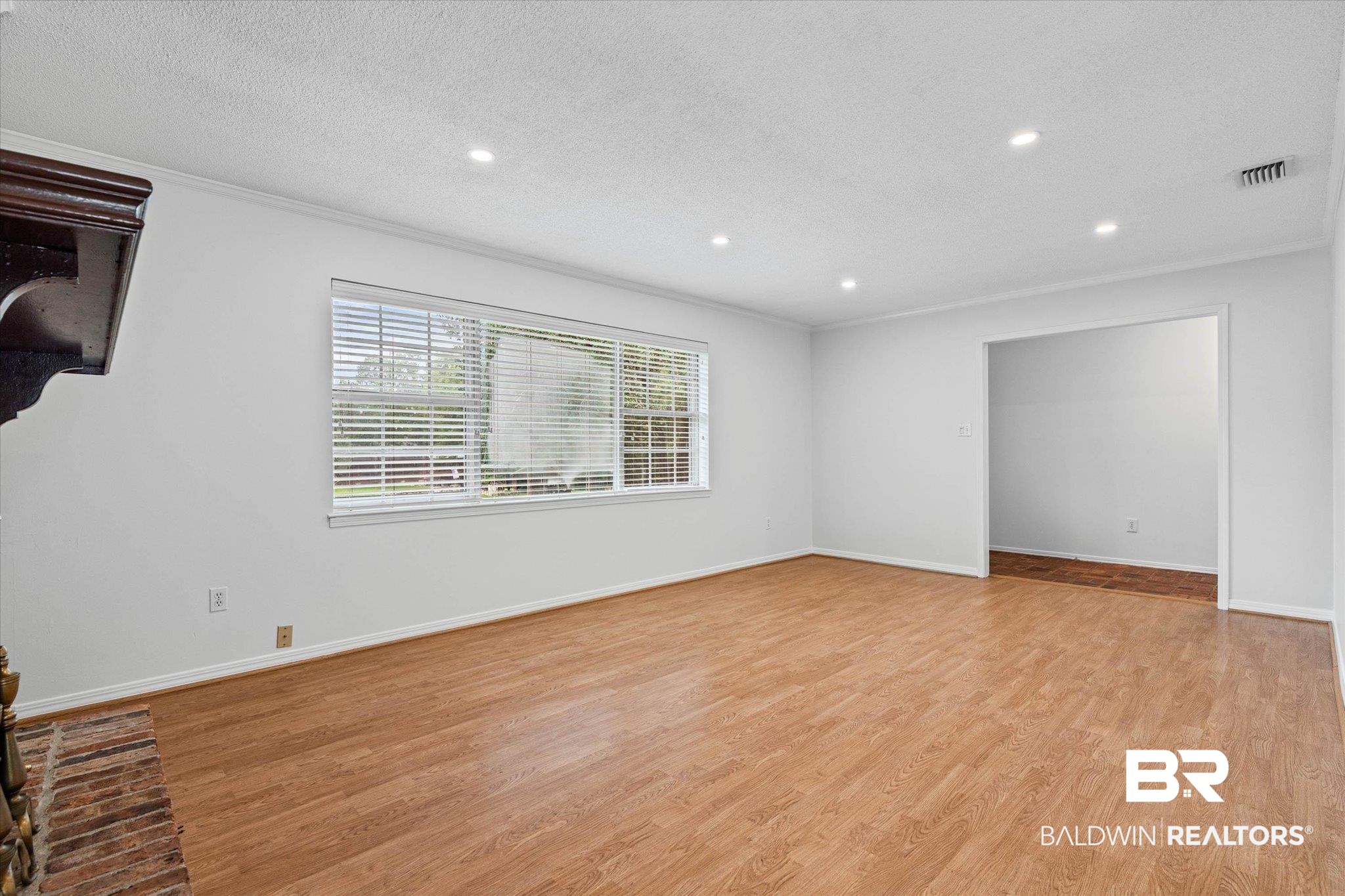 8301 Fordham Road Mobile, AL 36619 - Photo 4 of 57 Spacious interior room featuring wood-finish flooring, recessed lighting, and a brick fireplace with a wood mantle
