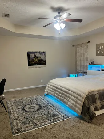 a bedroom with a bed and a chandelier