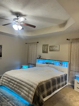 a bedroom with a bed and a chandelier