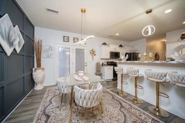 a kitchen with stainless steel appliances kitchen island granite countertop a sink and a refrigerator