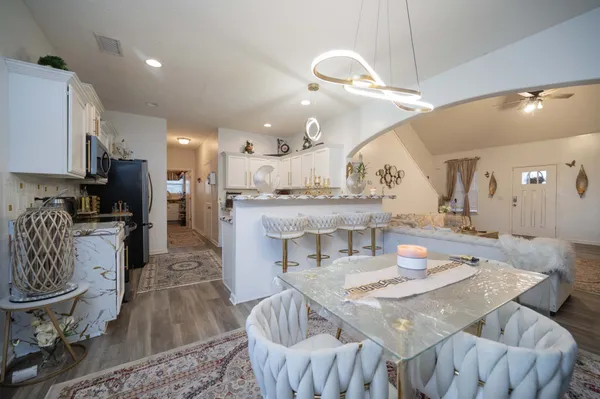 a large kitchen with a table and chairs