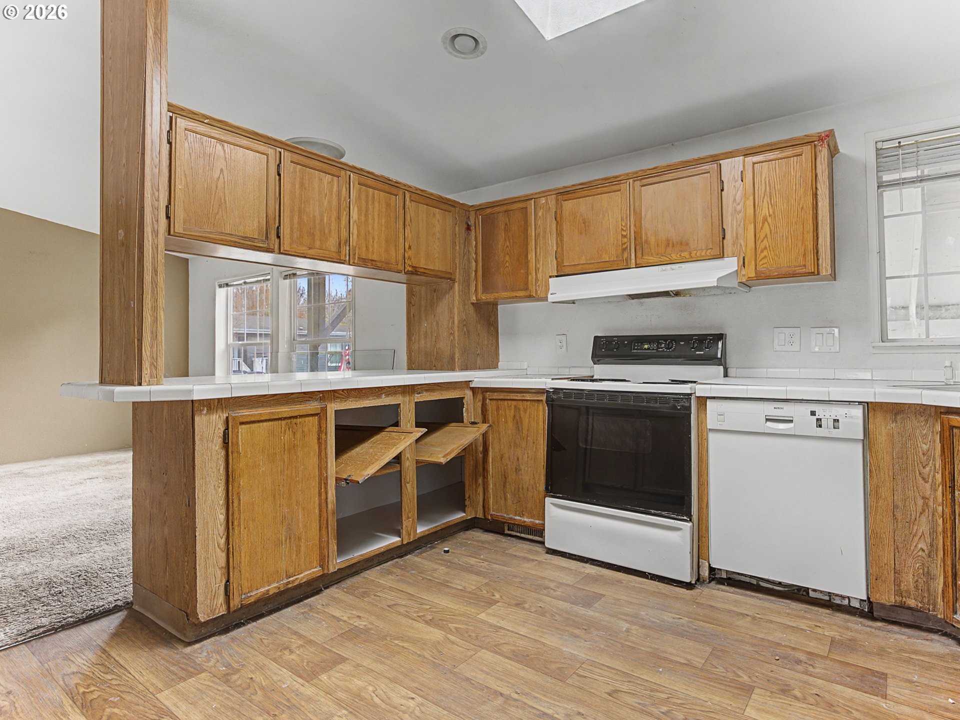 2965 Northeast 206th Place Fairview, OR 97024 - Photo 13 of 44 a kitchen with stainless steel appliances granite countertop a stove a sink and a microwave