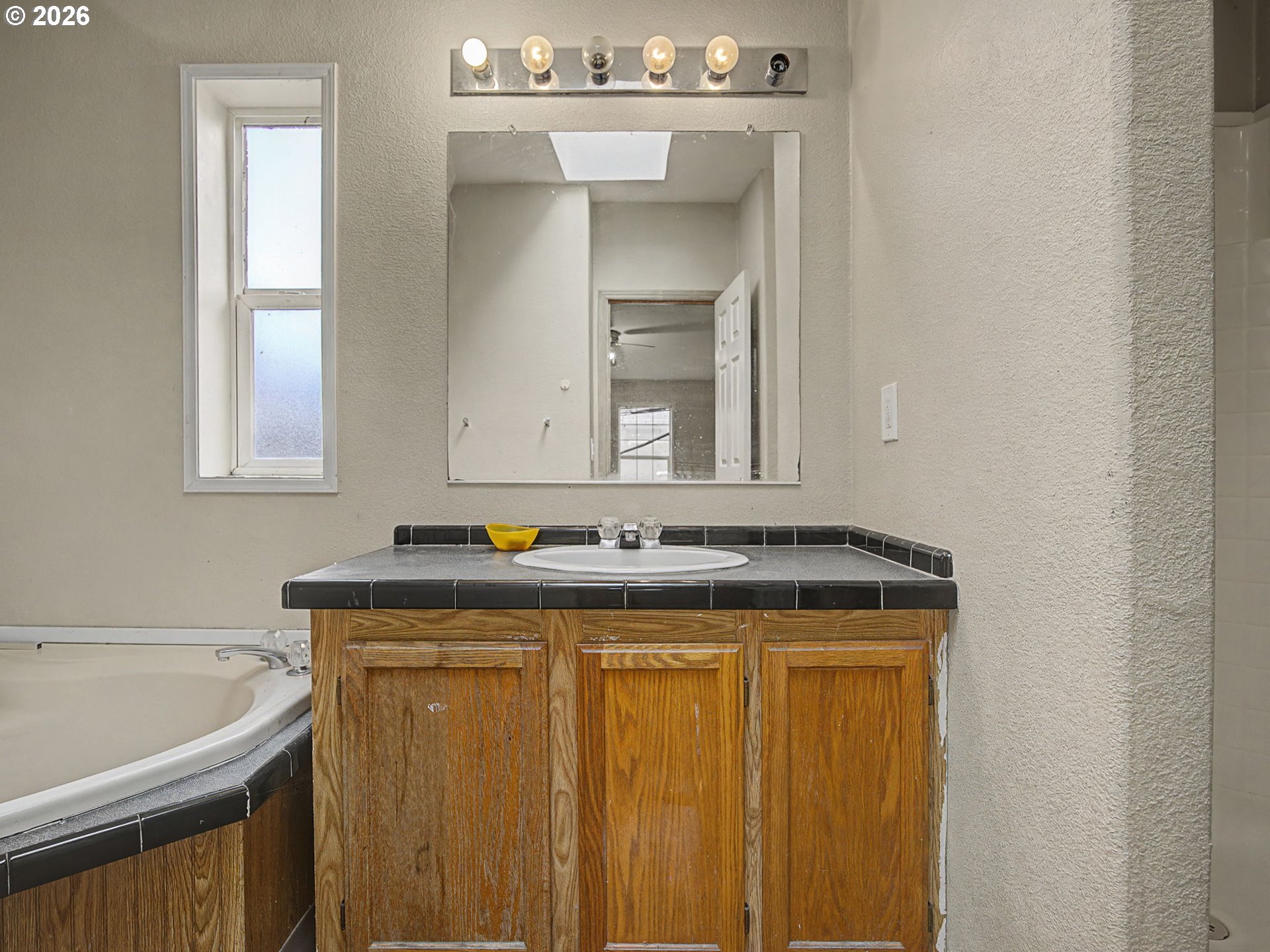 2965 Northeast 206th Place Fairview, OR 97024 - Photo 22 of 44 a bathroom with a granite countertop sink a mirror and a bathtub