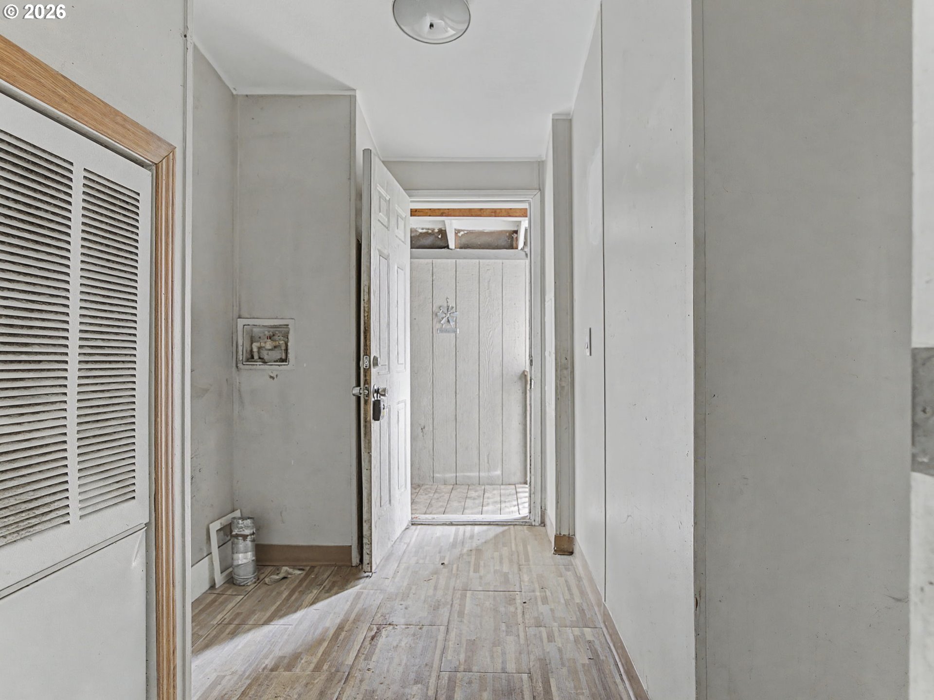 2965 Northeast 206th Place Fairview, OR 97024 - Photo 38 of 44 a view of a hallway with wooden floor and a bathroom
