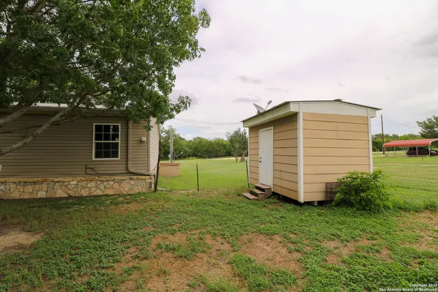 a backyard of a house with lots of green space