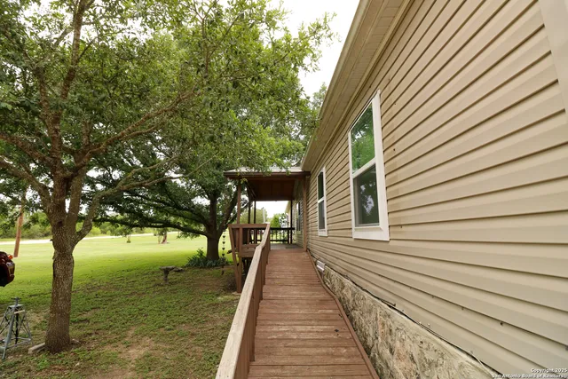 a view of a house with backyard and sitting area