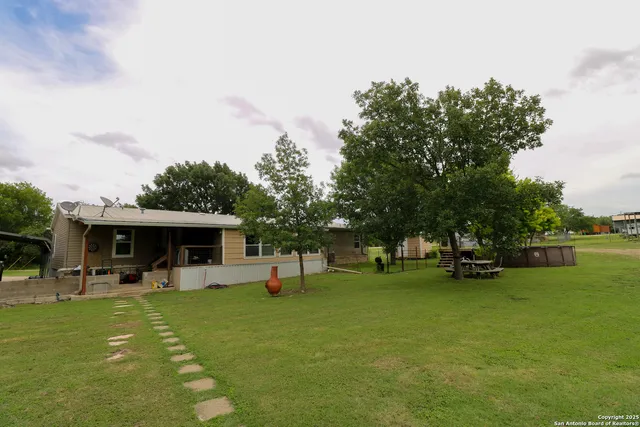 a view of a swimming pool with a table and chairs