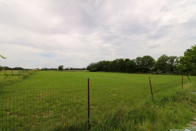 a view of an green field with clear sky