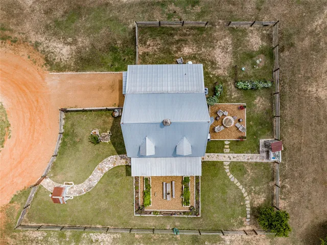 an aerial view of a house with swimming pool