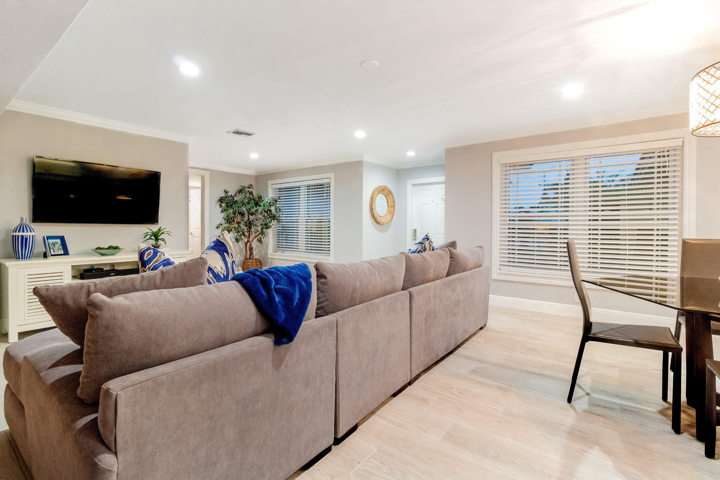 1241 Southwest 8th Street Boca Raton, FL 33486 - Photo 17 of 22 a living room with furniture and a flat screen tv