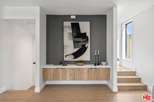 a view of entryway and hall with wooden floor