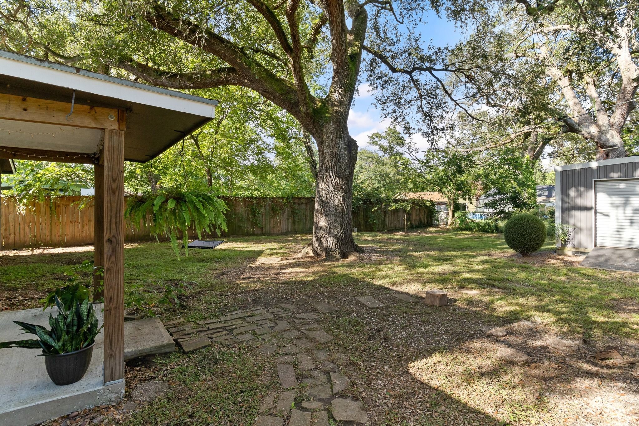 232 Laurel Street Lake Jackson, TX 77566 - Photo 2 of 22 a view of a yard with plants and a table and chair