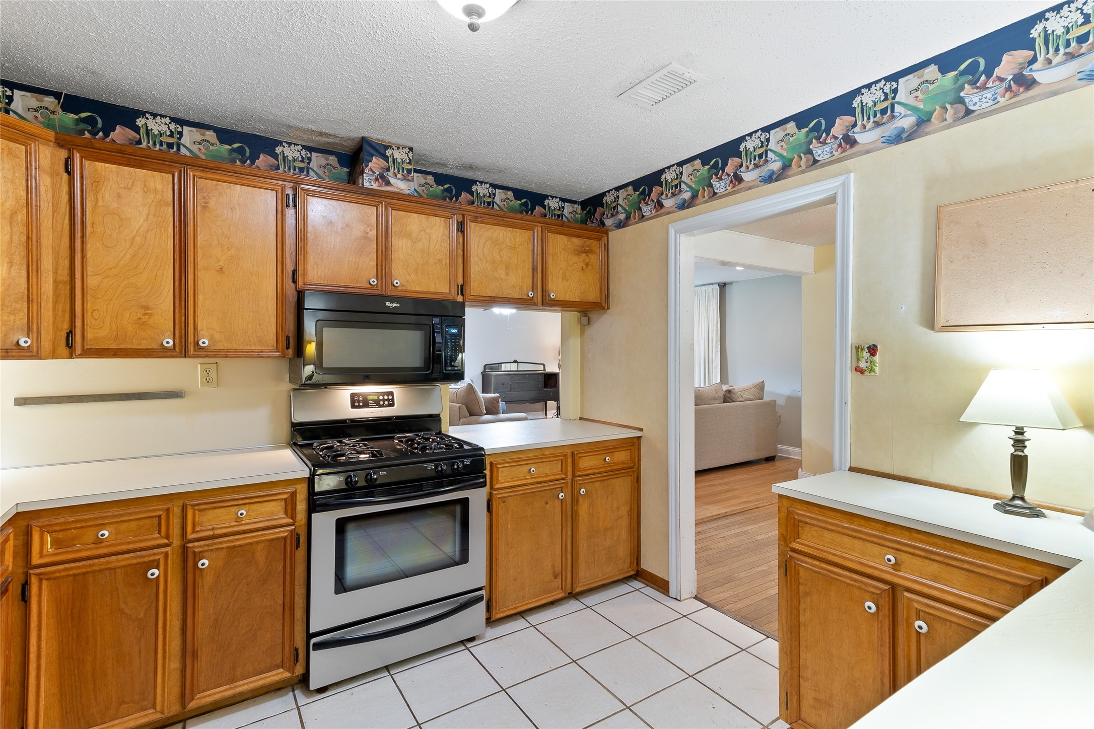 232 Laurel Street Lake Jackson, TX 77566 - Photo 8 of 22 a kitchen with stainless steel appliances a stove sink and cabinets
