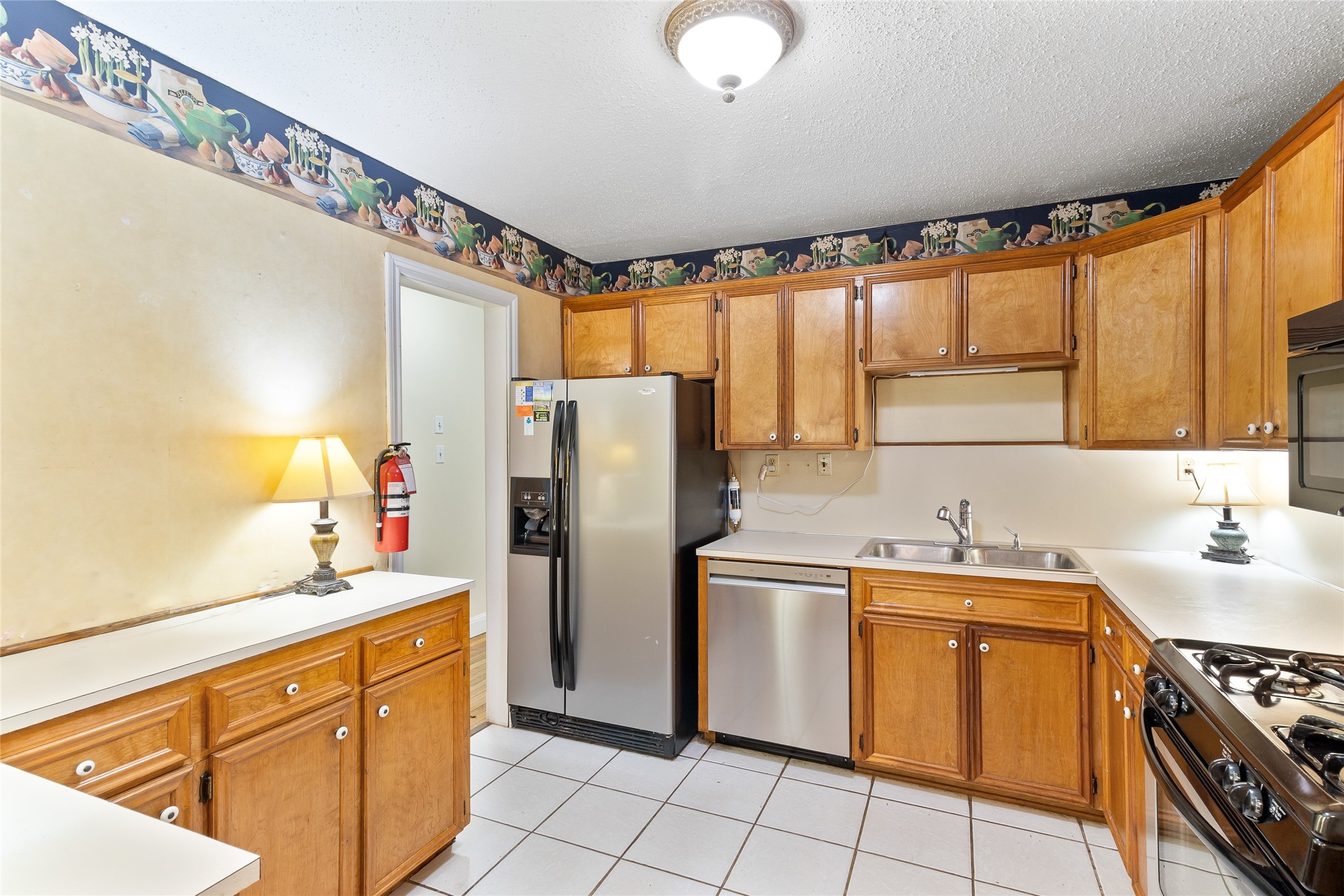 232 Laurel Street Lake Jackson, TX 77566 - Photo 9 of 22 a kitchen with stainless steel appliances granite countertop a refrigerator sink and stove