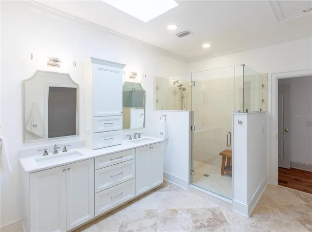 a bathroom with a double vanity sink mirror and double