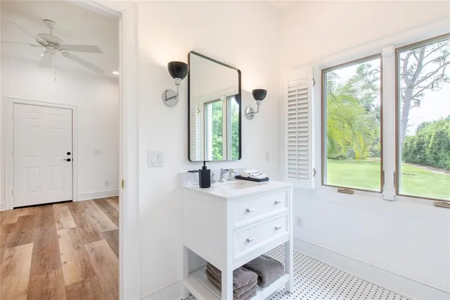 a room with a window and a dresser