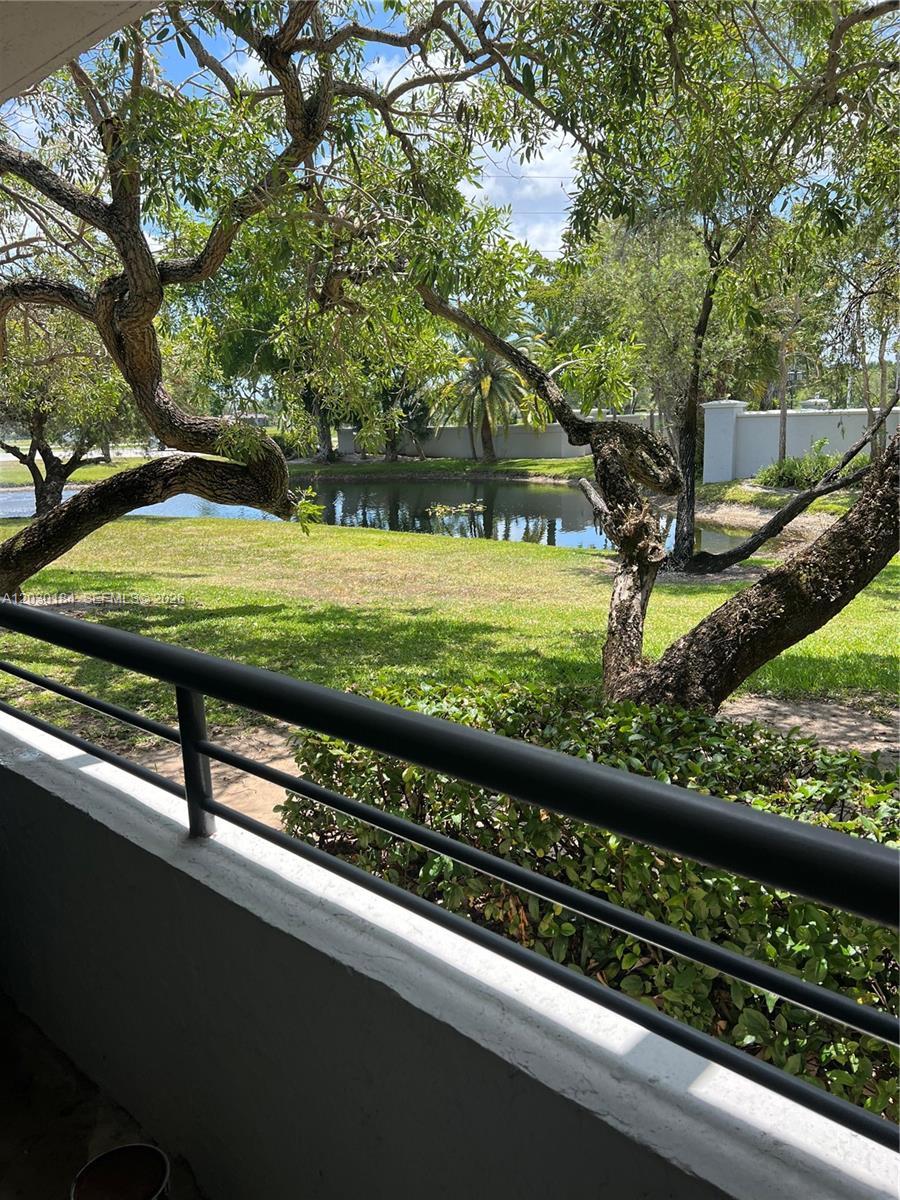 951 Lyons Road, Unit 6104 Coconut Creek, FL 33063 - Photo 12 of 18 a view of a backyard with wooden fence