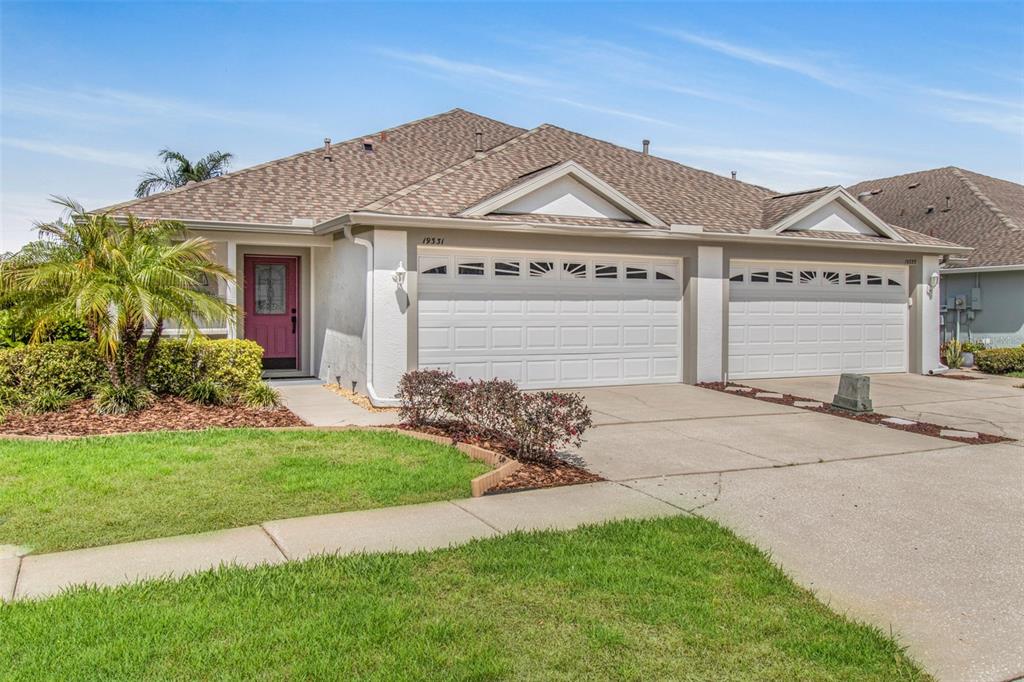 19331 Haskell Place Land O Lakes, FL 34638 - Photo 1 of 34 a front view of a house with garden