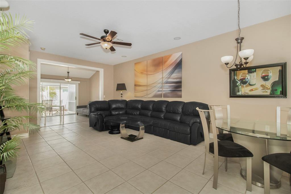 19331 Haskell Place Land O Lakes, FL 34638 - Photo 13 of 34 a living room with furniture and a chandelier