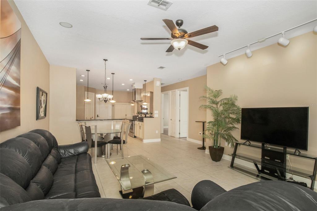 19331 Haskell Place Land O Lakes, FL 34638 - Photo 15 of 34 a living room with furniture and a flat screen tv
