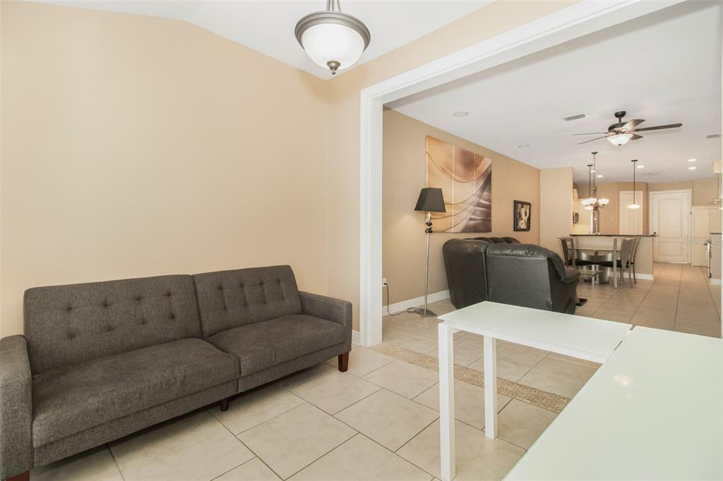 19331 Haskell Place Land O Lakes, FL 34638 - Photo 17 of 34 a living room with furniture kitchen view and a chandelier